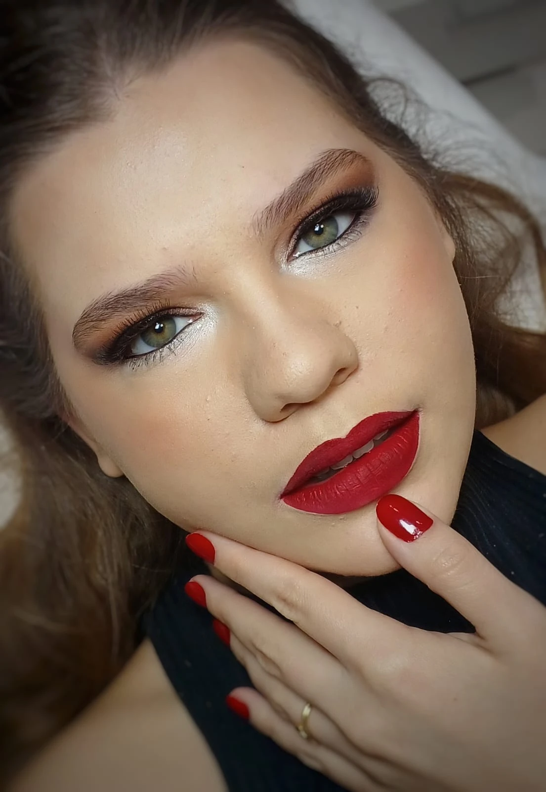 Maquiagem profissional com olhos marcados e batom vermelho